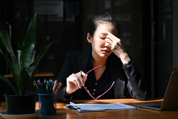 Balancing scales with work and relaxation symbols, representing burnout prevention strategies.